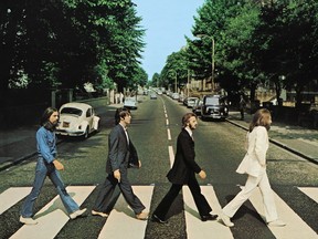 Members of the Beatles, George Harrison, Paul McCartney, Ringo Starr, John Lennon, cross Abbey Road in London, Britain, August 8, 1969.