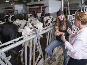 Marie-Claude Bibeau, Minister of Agriculture and Agri-Food, chats with farm owner Veronica Enright at her dairy farm in Compton, Que., Friday, Aug. 16, 2019.