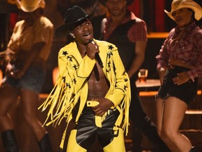 This June 23, 2019 file photo shows Lil Nas X performing "Old Town Road" at the BET Awards in Los Angeles. The rapper has taken his horse to the old town road and ridden it to the top of the Billboard charts for 16 weeks, tying a record set by Mariah Carey and Luis Fonsi.