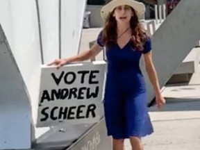 A woman holding a sign supporting Andrew Scheer went on a racist rant outside Toronto City Hall.