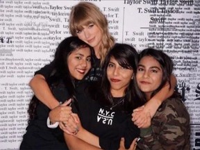 Taylor Swift poses with University of Waterloo student Ayesha Khurram, centre, after a concert at the Rogers Centre in Toronto on Aug. 3, 2018.