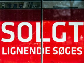 A sign reading "Sold - Looking For Similar" sits in the window of an estate agent in Copenhagen, Denmark. A Danish lender last week started offering home buyers 10-year mortgages at an interest rate of -0.5 per cent.
