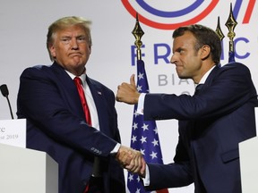 France's President Emmanuel Macron (R) and U.S. President Donald Trump shake hands during a joint-press conference in Biarritz, south-west France on August 26, 2019, on the third day of the annual G7 Summit attended by the leaders of the world's seven richest democracies, Britain, Canada, France, Germany, Italy, Japan and the United States.