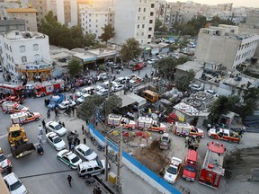 A picture taken on September 7, 2016 shows ambulance's and fire fighter vehicles gathering at the site of the Kianshahr subway tunnel following its collapse in the Iranian capital Tehran.
