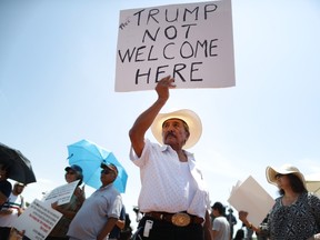 Miguel de Anda, born and raised in El Paso, holds a sign reading 'Trump Not Welcome Here' at a protest against President Trump's visit following a mass shooting, which left at least 22 people dead, on August 7, 2019 in El Paso, Texas.