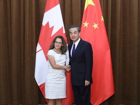 Canada's Foreign Minister Chrystia Freeland (L) shakes hands with her Chinese counterpart Wang Yi as she arrives for a meeting at the Ministry of Foreign Affairs in Beijing on August 9, 2017.