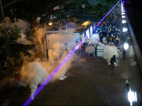 Demonstrators clash with riot police during a protest in the Tsim Sha Tsui district of Hong Kong, China, on Saturday, Aug. 3, 2019. Hong Kong on Saturday entered the second of four straight days of rallies, with hundreds of pro-police demonstrators gathering on one side of the harbour and thousands of anti-government protesters on the other.