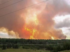 This screen grab from a video made on August 5, 2019 shows explosions at an ammunition depot near the town of Achinsk in the Krasnoyarsk region. Up to eight people were injured and thousands were evacuated on August 5, 2019 because of a fire at a Siberian ammunition depot that set off explosions, authorities said.