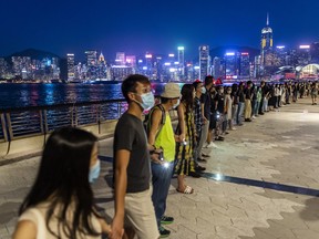 Demonstrators join hands to form a human chain during the Hong Kong Way event in the Tsim Sha Tsui district of Hong Kong, China, on Friday, Aug. 23, 2019. Hong Kong protesters are gearing up for a 12th straight weekend of demonstrations that have rocked the former British colony and raised questions about its future as a top regional financial hub.