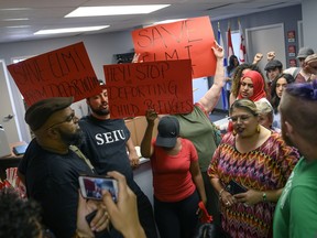 Demonstrators chant in MP Andy Fillmore's constituency office advocating for a stay on the deportation of Abdilahi Elmi to Somalia during a protest in Halifax on Tuesday, August 20, 2019. Included in the group advocating for the stay was Fatuma Abdi, the sister of Abdoul Abdi, the former refugee youth in care who successfully stayed his deportation.