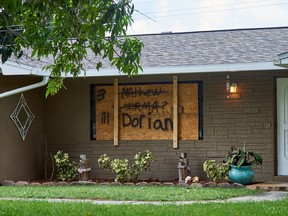 Plywood displaying the names of previous hurricanes protects windows of a house ahead of Hurricane Dorian in Cocoa Beach, Florida, U.S., on Thursday, Aug. 29, 2019. Hurricane Dorian is now expected to become a Category 4 storm, with winds reaching 130 miles per hour within 72 hours as it barrels toward Florida’s east coast, aiming to become the first major hurricane to hit that area in 15 years.