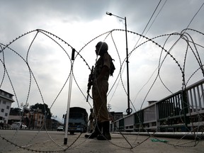 A security personnel stands guard on a street during a lockdown in Srinagar on August 11, 2019, after the Indian government stripped Jammu and Kashmir of its autonomy.