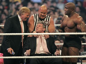 WWE chairman Vince McMahon has his head shaved by Donald Trump and Bobby Lashley, right, while being held down by ''Stone Cold'' Steve Austin after losing a bet in the Battle of the Billionaires at the 2007 World Wrestling Entertainment's Wrestlemania on April 1, 2007, in Detroit, Mich.