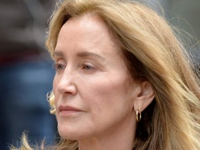 Actress Felicity Huffman is escorted by police into court where she is expected to plead guilty to one count of conspiracy to commit mail fraud and honest services mail fraud before Judge Talwani at John Joseph Moakley United States Courthouse in Boston, Massachusetts, May 13, 2019.