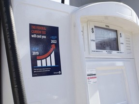 A gas pump displays an anti-carbon tax sticker in Toronto on Thursday, August 29, 2019.