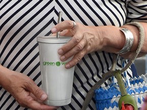 Elizabeth May, leader of the Green Party, with the photoshopped coffee cup.