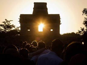 The sun is seen through the door of the Seven Dolls Temple, in the Maya archaeological site of Dzibilchaltun, in Yucatan State, Mexico, as it rises on September 21, 2019, two days ahead of the Autumn Equinox.