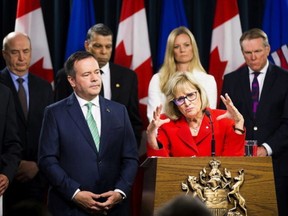 Premier Jason Kenney listens in early May to Janice MacKinnon, a former Saskatchewan finance minister and chair of a blue-ribbon panel announced to examine the Alberta government's financial situation.