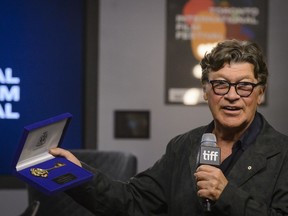 Robbie Robertson is presented with a key to the city by Toronto Mayor John Tory during a press conference to promote the movie "Once Were Brothers: Robbie Robertson and The Band" during the 2019 Toronto International Film Festival in Toronto., on Thursday, Sept. 5, 2019.