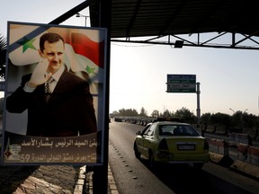 A poster of Syrian President Bashar al-Assad is seen on the main road to the airport in Damascus, Syria April 14, 2018.