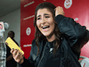 Bianca Andreescu laughs after reading a text message from rapper Drake as she speaks to reporters about her win at the U.S. Open, in Toronto on Sept. 11, 2019.