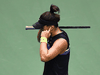 Bianca Andreescu protects her ears as fans cheer for Serena Williams during their U.S. Open finals match.