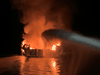 Ventura County Fire Department personnel shoot water at a fire on the 75-foot Conception off Santa Cruz Island, California, on Sept. 2, 2019.