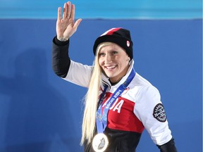 Gold medalist Kaillie Humphries waves to the crowd during the women's bobsleigh medal ceremony at the Sochi 2014 Winter Olympics.