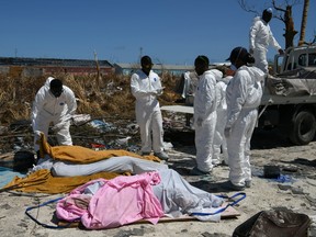 Personnel from the Royal Bahamas Police Force remove bodies recovered in a destroyed neighbourhood in the wake of Hurricane Dorian in Marsh Harbour, Great Abaco, Bahamas, September 9, 2019.