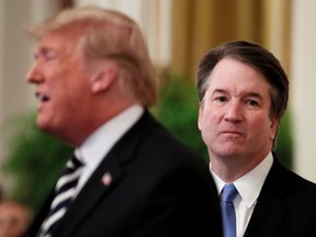 President Donald Trump speaks next to U.S. Supreme Court Associate Justice Brett Kavanaugh as they participate in a ceremonial public swearing-in in the East Room of the White House in Washington, U.S., October 8, 2018.