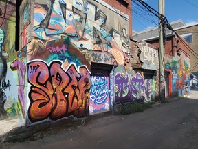 A section of Graffiti Alley showing works by multiple artists featured within the ON-FOOT app. The alley is found just south of Queen St between Spadina Ave and Portland St.