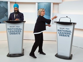 Green Party leader Elizabeth May shakes hands with invisible-prime minister Justin Trudeau, who turned down an invitation to the Maclean's/Citytv National Leaders Debate, in Toronto, Ontario, Canada September 12, 2019.