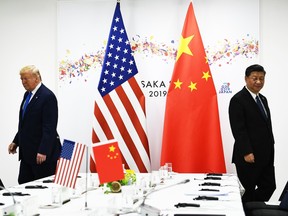 In this file photo taken on June 29, 2019 Chinese President Xi Jinping (R) and US President Donald Trump attend their bilateral meeting on the sidelines of the G20 Summit in Osaka.