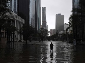 A man stands in a flooded street as Hurricane Irma hits Miami on Sept. 10, 2017.