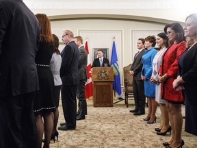 Alberta's United Conservative government is eliminating stand-alone offices for climate change policy and environmental monitoring. Alberta Premier Jason Kenney watches as his cabinet is sworn into office in Edmonton on Tuesday, April 30, 2019.