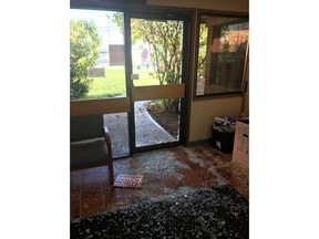 Broken glass covers the floor of an entranceway after a moose smashed its way into the Peace River North School District office in Fort St. John, B.C., in a Thursday, Sept. 12, 2019, handout photo.