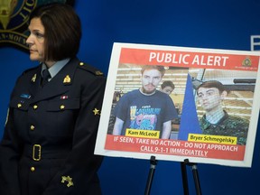 Security camera images recorded in Saskatchewan of Kam McLeod, 19, and Bryer Schmegelsky, 18, are displayed as RCMP Sgt. Janelle Shoihet listens during a news conference in Surrey, B.C., on July 23, 2019. The RCMP will release its investigative findings on Friday into the killing of three people in northern British Columbia that sparked a manhunt for two teenage suspects across Western Canada. Bryer Schmegelsky, who was 18, and Kam McLeod, who was 19, were found dead of self-inflicted gunshot wounds last month in the wilderness of northern Manitoba. Schmegelsky and McLeod were charged with the murder of Leonard Dyck, a University of British Columbia botany lecturer, and were also suspects in the deaths of American Chynna Deese and her Australian boyfriend Lucas Fowler.