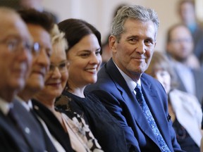 Premier Brian Pallister looks at some of his new provincial MLAs who were sworn into the Manitoba legislature in Winnipeg on September 25, 2019. Manitoba politicians are returning to the legislature for the first time since the provincial election three weeks ago. Premier Brian Pallister has said a short throne speech laying out his priorities will start the abbreviated, two-week session.