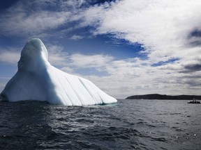Trinity Eco-Tours take tourists up close to an iceberg in Bonavista Bay, Newfoundland and Labrador on June 11, 2019. A new report from an international scientific panel concludes that damage to Earth's oceans and glaciers from climate change is outpacing the ability of governments to protect them. The Intergovernmental Panel on Climate Change report concludes that if nothing improves, the effects will be severe -- and Canada will not escape.