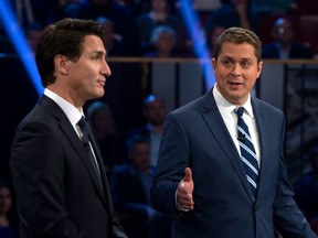 Conservative leader Andrew Scheer (R) makes a point with Canadian Prime Minister and Liberal leader Justin Trudeau as they discuss a question during the Federal Leaders Debate at the Canadian Museum of History in Gatineau, Quebec on October 7, 2019.