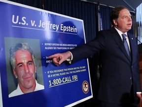 Geoffrey Berman, United States Attorney for the Southern District of New York, points to a photograph of Jeffrey Epstein as he announces the financier's charges of sex trafficking of minors and conspiracy to commit sex trafficking of minors, in New York, U.S., July 8, 2019.