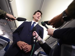 Liberal Leader Justin Trudeau responds to a question after making a statement in regards to photo coming to light of himself from 2001 wearing "brownface" during a scrum on his campaign plane in Halifax, N.S., on Wednesday, September 18, 2019.
