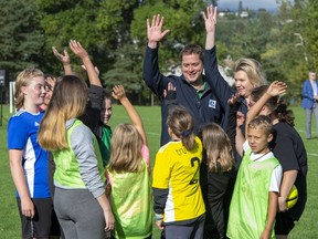 Federal Conservative leader Andrew Scheer and his wife Jill conduct a cheer with children playing soccer at a campaign event in Kelowna, B.C. on Monday September 16, 2019.