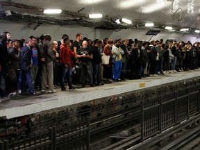 Commuters wait to board a metro at the Gare du Nord subway station during a strike by all unions of the Paris transport network (RATP) against pension reform plans in Paris, France, September 13, 2019.