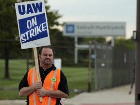 An Aramark employee pickets outside of General Motors Co. Hamtramck assembly plant in Detroit, Michigan, U.S., on Sunday, Sept. 15, 2019. About 850 Aramark workers, represented by the United Auto Workers (UAW), in Michigan and Ohio went on strike over better wages, healthcare and retirement benefits.