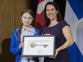Swedish climate activist Greta Thunberg, left, receives the key to the city from Montreal mayor Valerie Plante during a ceremony in Montreal, Friday, Sept. 27, 2019.