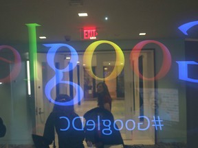 People stand in the lobby of Google's Washington headquarters, January 8, 2015, in Washington, D.C.