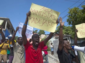 Demonstrators chant slogans during a protest against the United Nations peacekeeping mission, in Port-au-Prince, Haiti, Friday, Oct. 19, 2012.