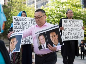 Uyghur activists protest China's treatment of Uyghurs outside a court appearance for Huawei Chief Financial Officer Meng Wanzhou at the British Columbia Supreme Court in Vancouver, on May 8, 2019.