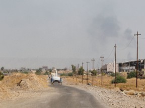 Iraqi mine clearers working with the Halo Trust, a non-profit organization specializing in mine removal, prepares to scan an agricultural area on August 25, 2019 near Iraq's Baiji, an oil-rich region ravaged by fighting against the Islamic State group in 2014.